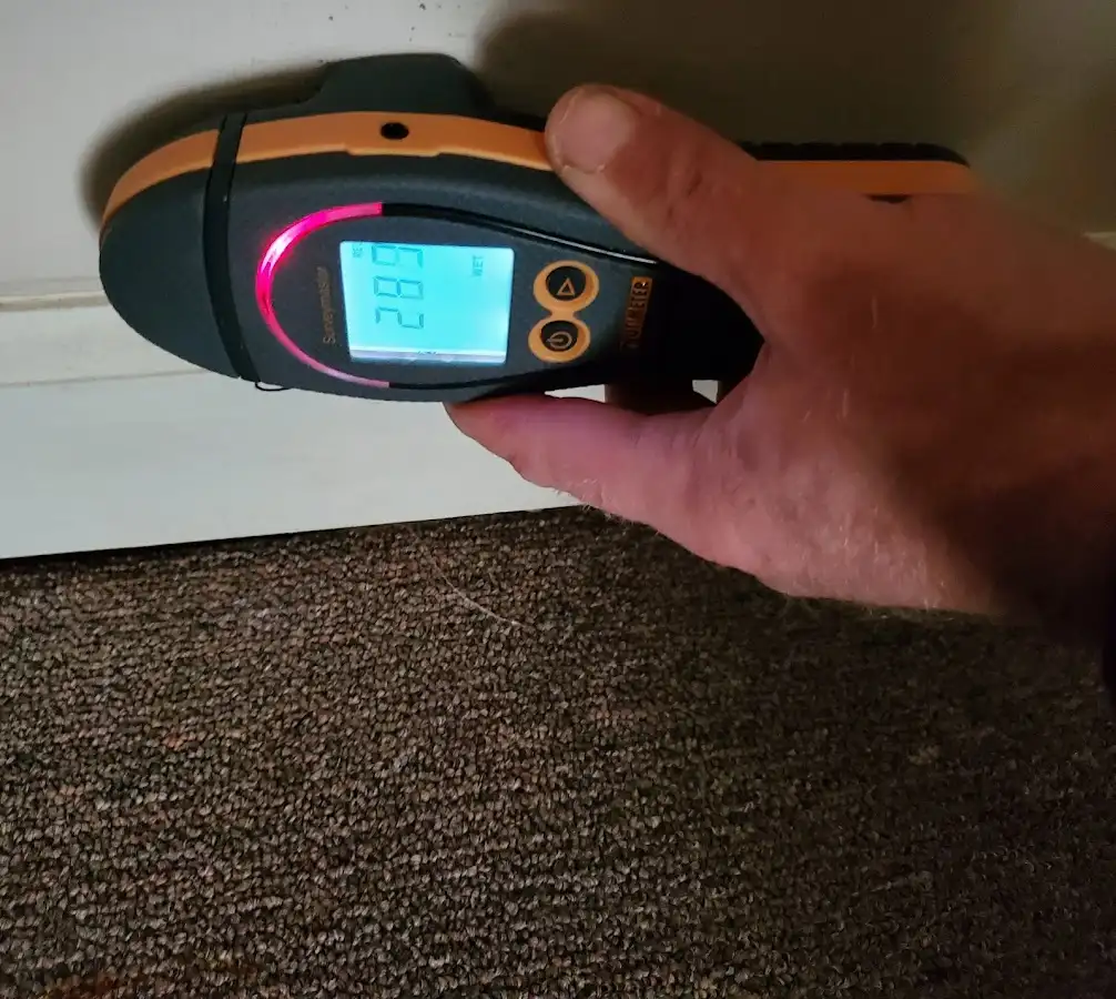 Moisture detection at baseboard during Storm Damage Restoration in Clarksville